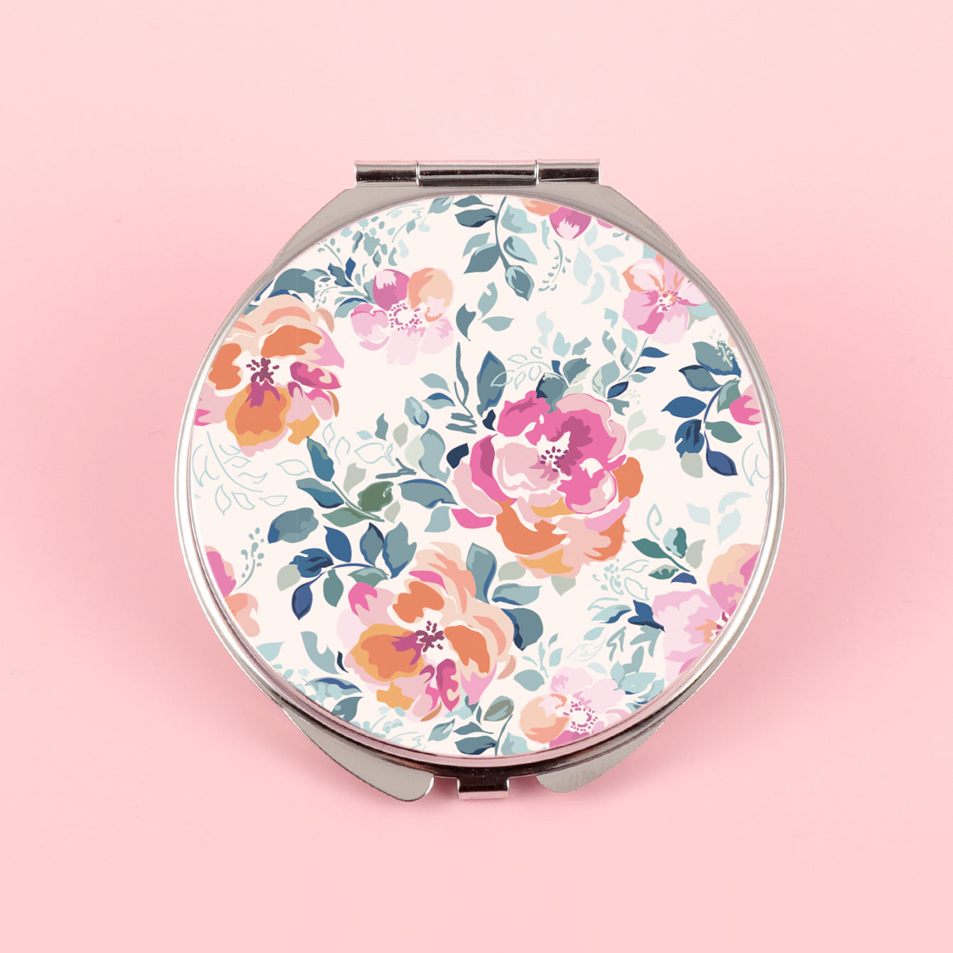 The silver plated round double-sided makeup mirror has a colored glue drop pattern. One side is normal size and the other side is double enlarged. You can customize the pattern yourself.