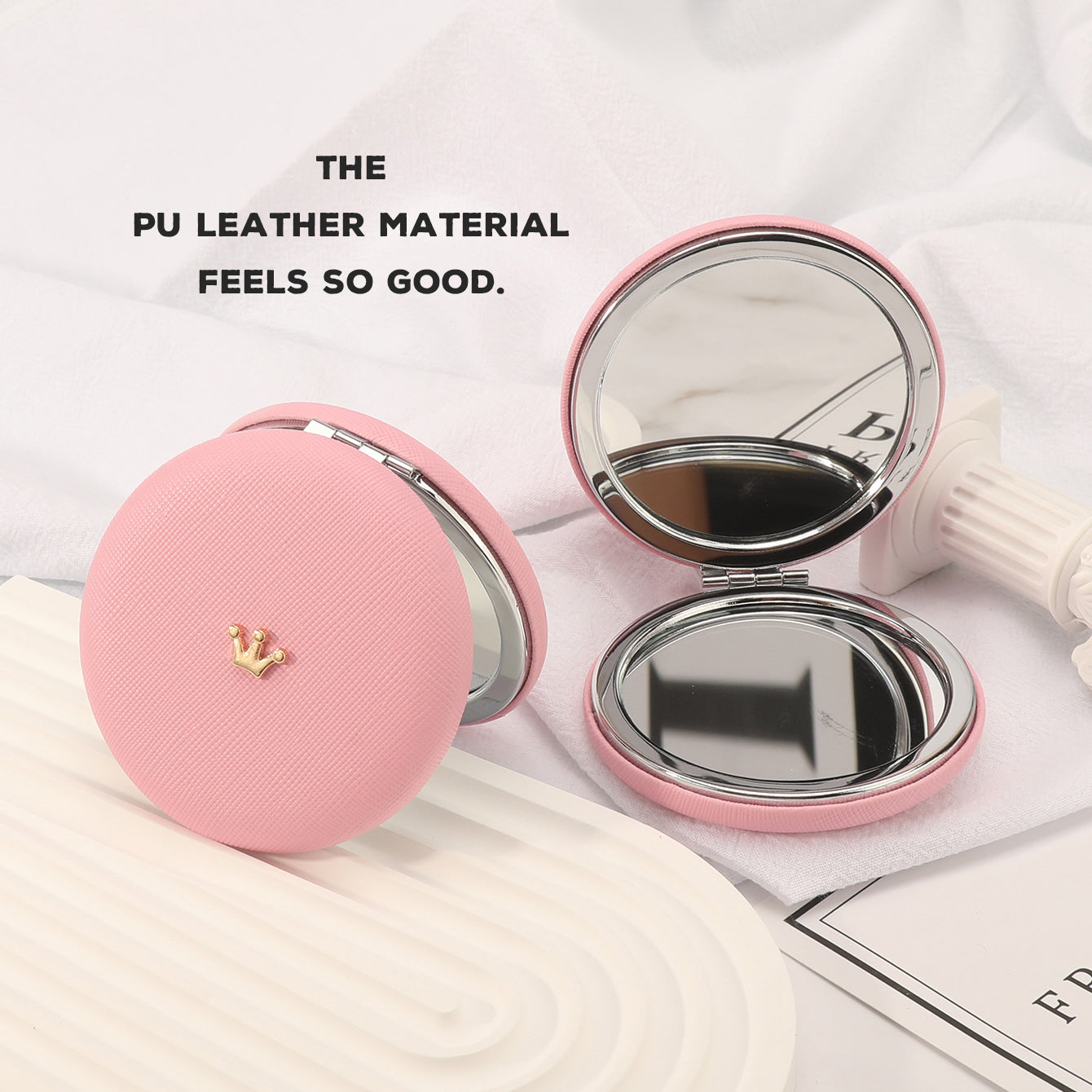 A 70* 70mm round PU leather bread mirror with small metal accessories and customizable patterns. It has a silver plated frame. The leather colors are available in black, red, khaki, and off-white pink.