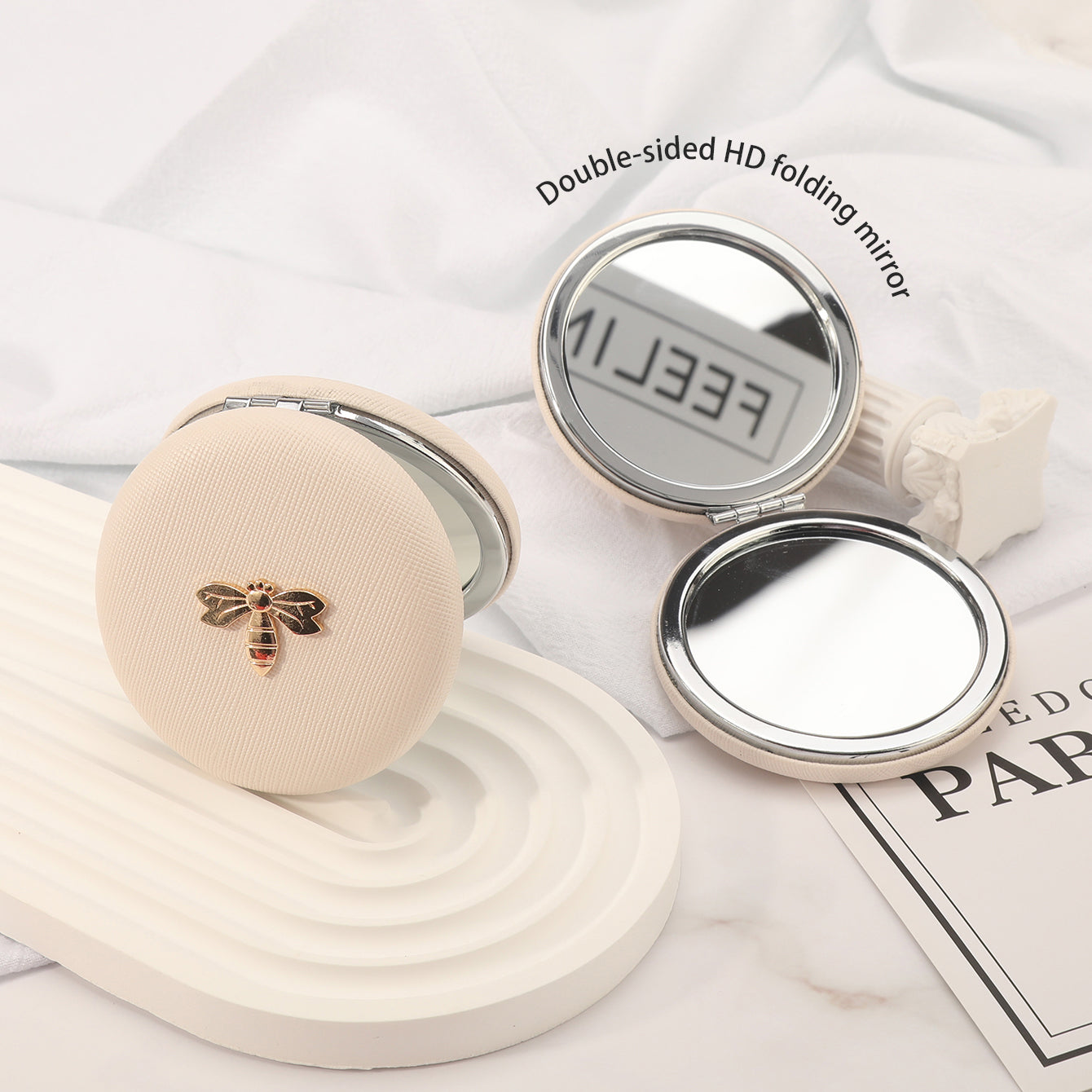 7cm Double-Sided Macaron Shaped Makeup Mirror with Silver-Plated Metal Frame – the ultimate gift for friends on holidays and birthdays! 🎁 In stock: black, red, pink, and beige. Adorned with a charming metallic Bee.