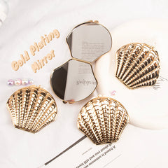 DIY Delight! In-stock Blank Seashell-shaped Makeup Mirror, 70mmX80mm, available in Rose Gold and Silver. Unleash your creativity and craft your own makeup masterpiece