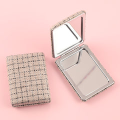 Chic 85*62mm Fabric Square Grid Makeup Mirror with Plating Silver Metal Frame, Available in White, Purple, and Khaki. Perfect for a refined look anytime, anywhere