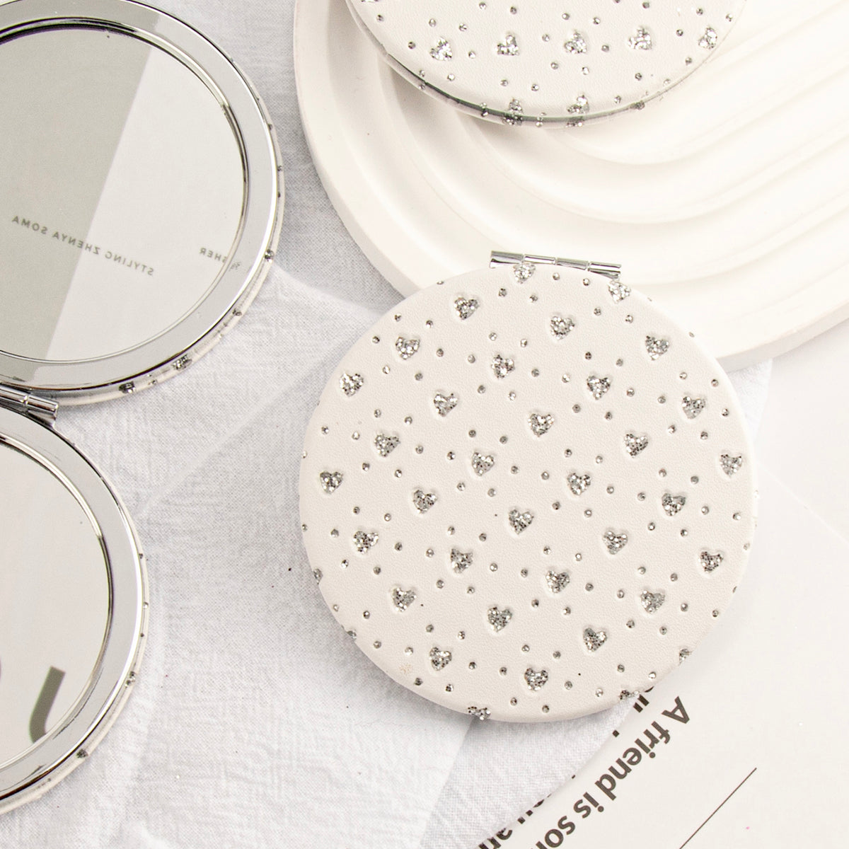 ✨ Trendy 70mm Circular Makeup Mirror, Silver Plated with Heart-shaped Elegant Leather Wrap. Double-sided with 2X Magnification, High-Definition Glass, In Stock for Quick Delivery. Perfect for DIY Beauty! 💄✨"