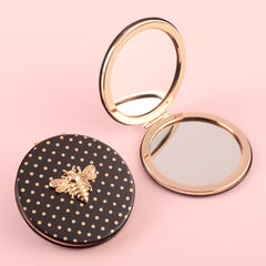 Stylish And Compact 70*70mm Round Cosmetic Mirror, PU Eco-Friendly Leather And Spot Pattern Complement Each Other, The Little Bee Metal Embellishment Adds A Sense Of Playfulness, And The Plating Gold Frame Has A High-End Feel