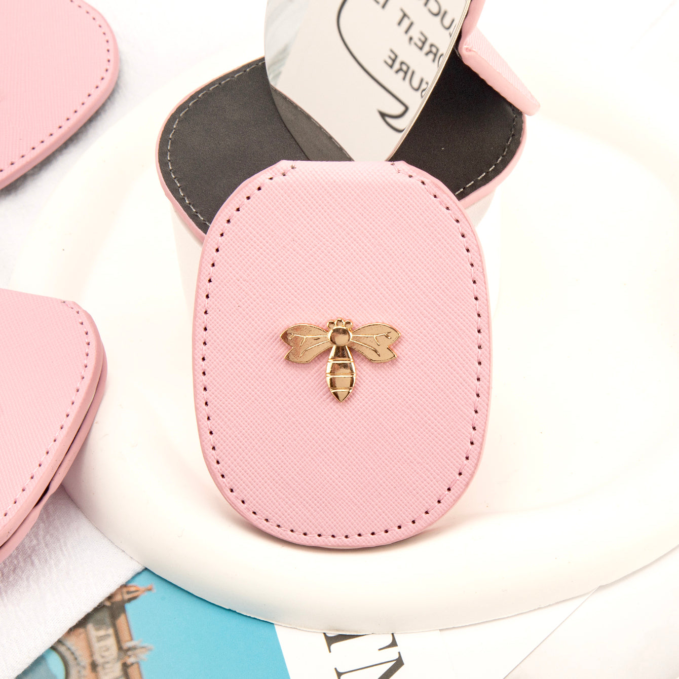 PU Eco-Friendly Leather with Bee Metal Decoration. Stainless Steel Cosmetic Mirror, 80*65mm Oval, Available in White, Pink, Light Pink, and Khaki.